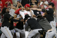 Cincinnati Reds relief pitcher Amir Garrett (50) throws punches as he is held back by a number of Pittsburgh Pirates players as a bench clearing brawl breaks out in the ninth inning of the MLB National League game between the Cincinnati Reds and the Pittsburgh Pirates at Great American Ball Park in downtown Cincinnati on Tuesday, July 30, 2019.